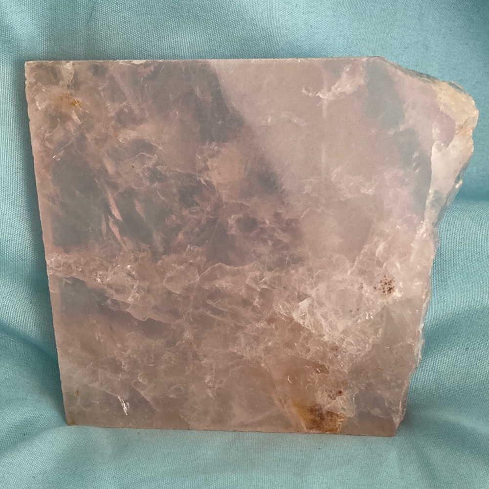 Rose quartz slab. Clear with lots of inclusions.4” Wide x 4” Tall x 1/2” Thick